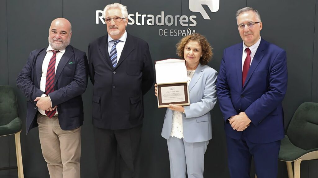 La Junta Directiva de ACIJUR homenajeó a la decana del Colegio de Registradores, María Emilia Adán, en reconocimiento a su colaboración. En la foto, de izquierda a derecha, Carlos Capa, secretario, Xavier Gil Pecharromán, presidente, María Emilia Adán, decana del Colegio de Registradores con la placa conmemorativa que le fue entregada, y Carlos Berbell, vicepresidente. Foto: ACIJUR.